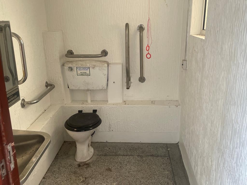 Lot: 140 - FORMER PUBLIC CONVENIENCES - Accessible toilet cubicle with toilets and wash basin